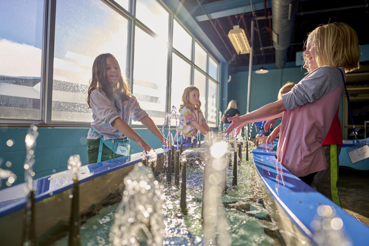 Girls playing in water at Impression 5 Science Museum
